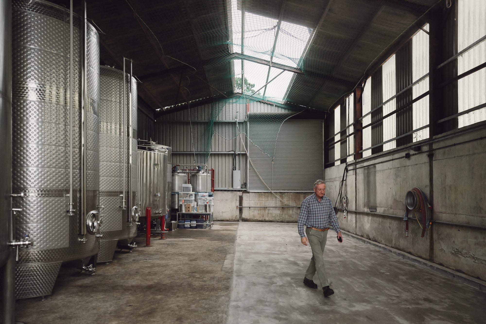 Robert Robinson walking through Robinsons' Cider Works in Little Hereford. Repairing the roof.